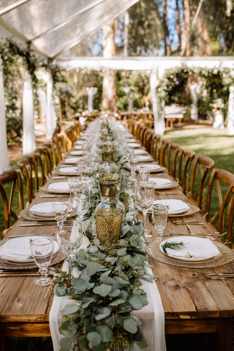 3. Anchor a Long Table with Greenery and Gold Glow