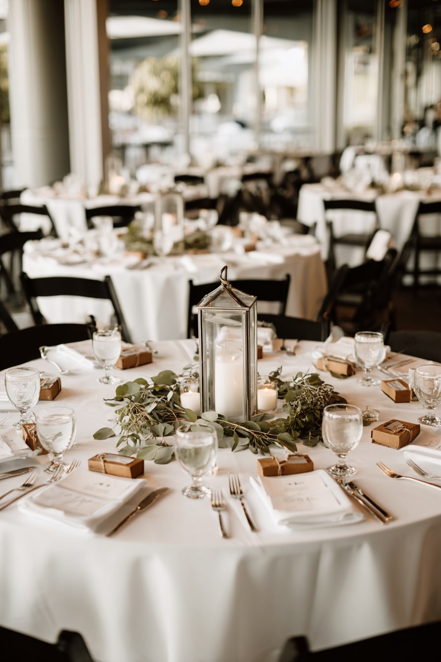 10. Anchor Each Table with a Lantern and Greenery Ring